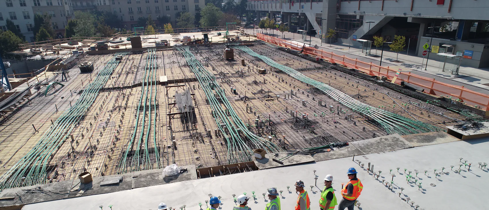 Aerial view of an engineering team standing on a freshly poured concrete slab